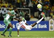 Nigeria's Joseph Yobo (L) fights for the ball with Burkina Faso's Jonathan Pitroipa in Nelspruit on January 21, 2013